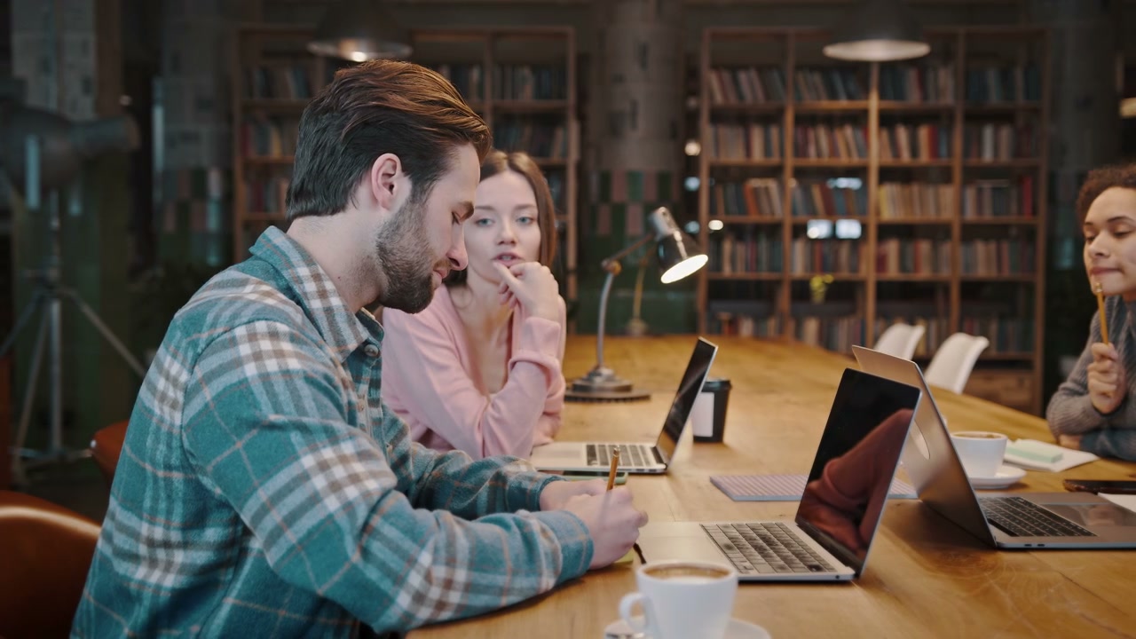 Coworkers Brainstorming Ideas in a Library