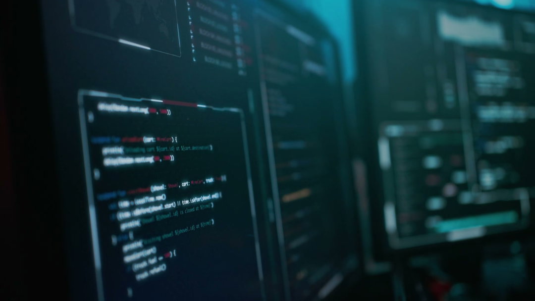 Hacker Eating and Coding on Multiple Monitors • Stock Video on Uppbeat