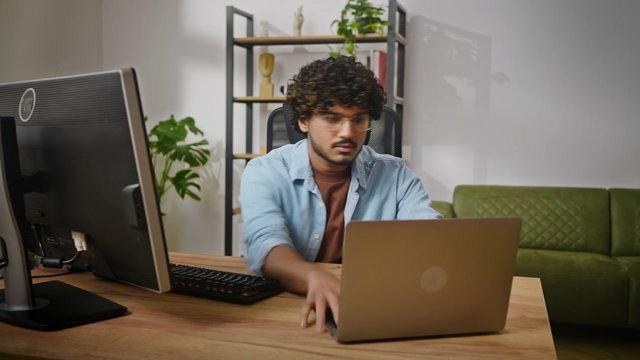 Young Man Typing at Computer in Office • Stock Video on Uppbeat
