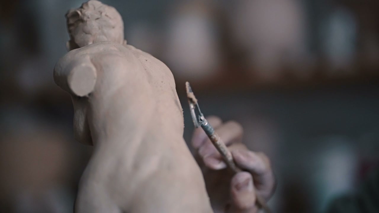 Sculptor Refining Clay Torso Sculpture
