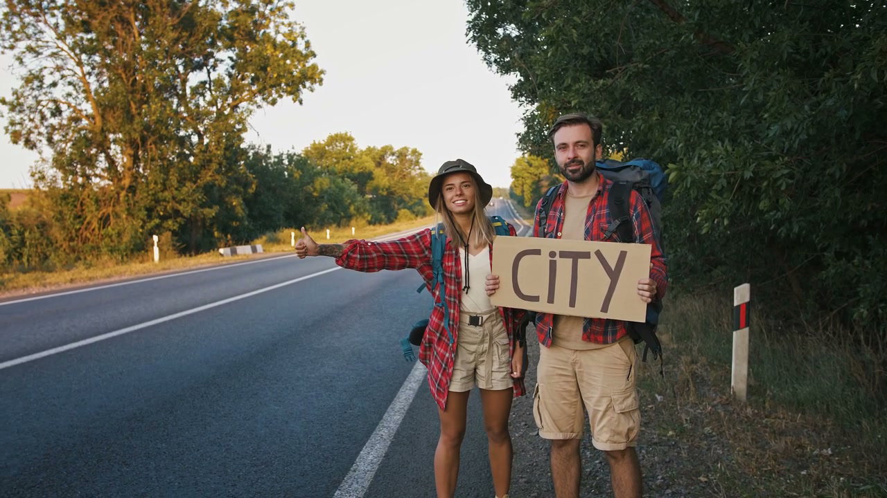 Couple Hitchhiking With City Sign