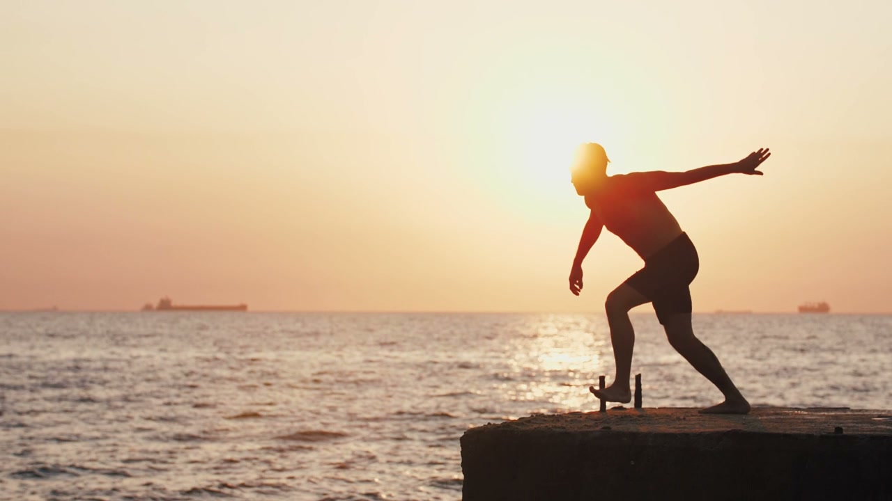 Man Backflips into Ocean at Sunset