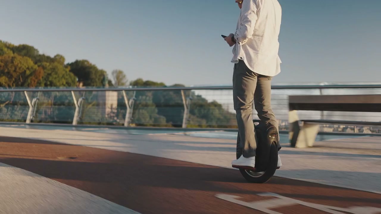 Man Riding Electric Unicycle on Urban Bridge