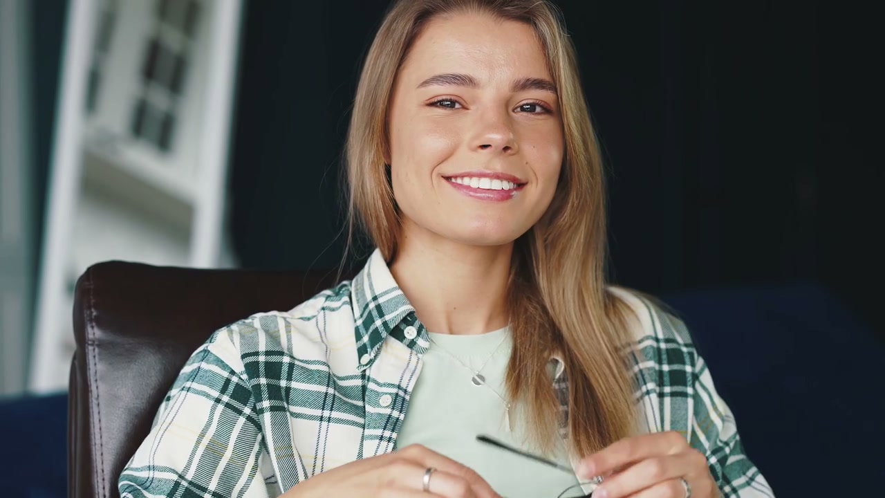 Smiling Woman Removing Glasses