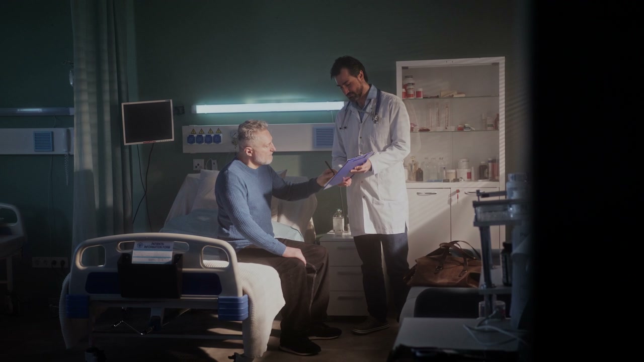 Patient Signs Documents, Shakes Doctor's Hand