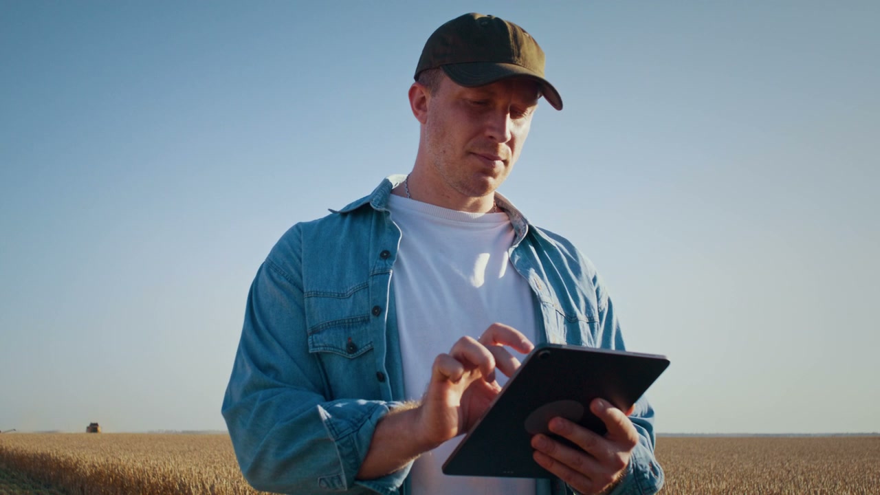 Farmer Using Tablet in Harvested Field