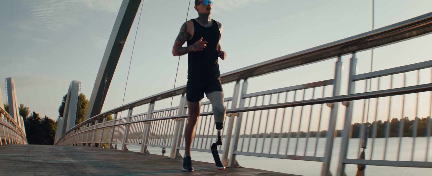Prosthetic Runner on Bridge at Sunrise