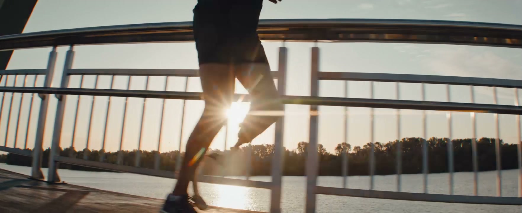 Prosthetic Runner on Bridge During Golden Hour