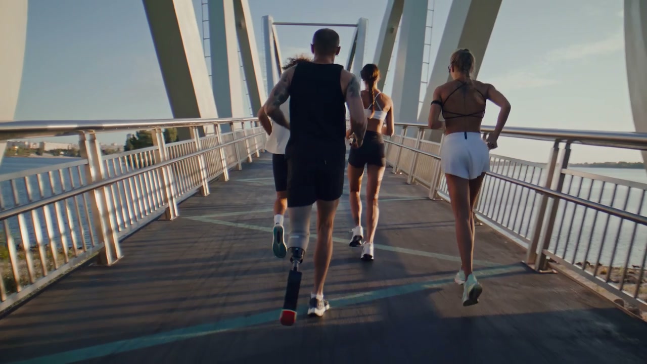 Man With Prosthetic Leg Running With Group