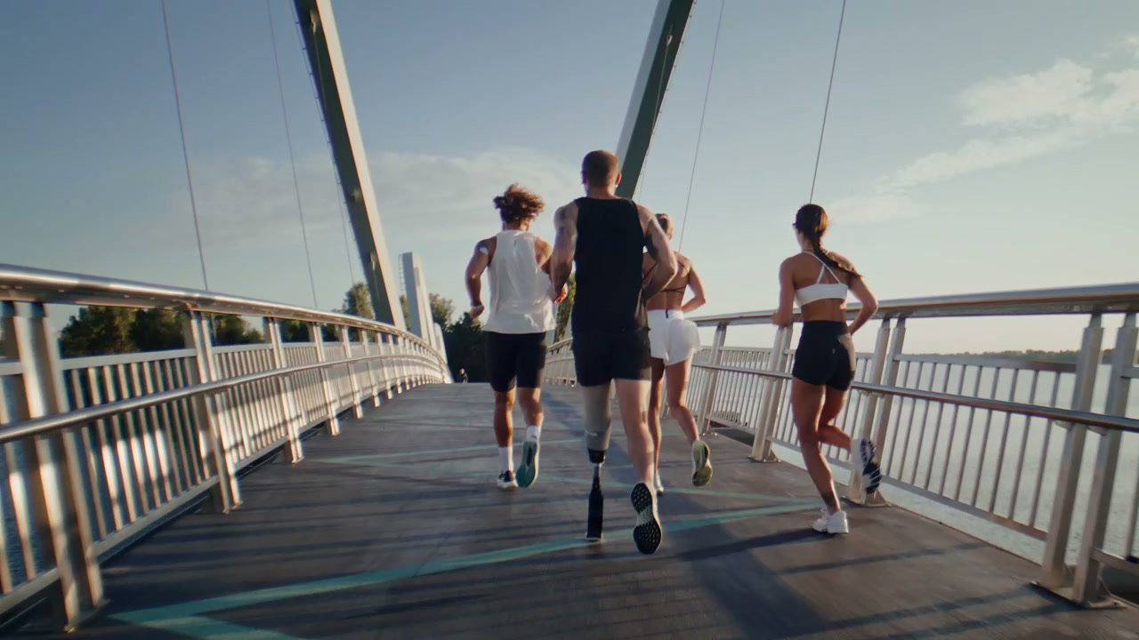 Professional Runners with Prosthetic Leg on Bridge