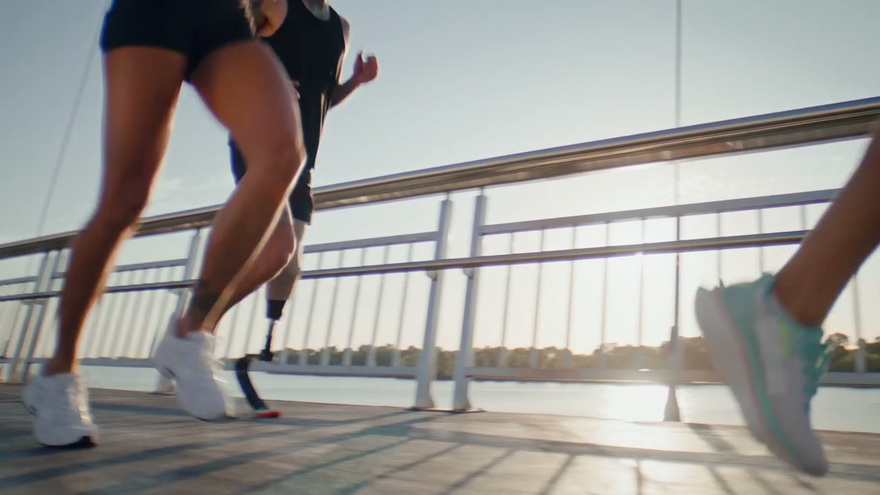Diverse Group of Runners Training on Bridge