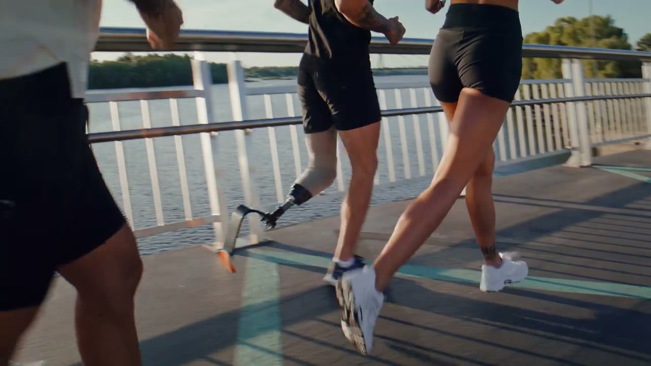 Diverse Group of Runners Training on Bridge