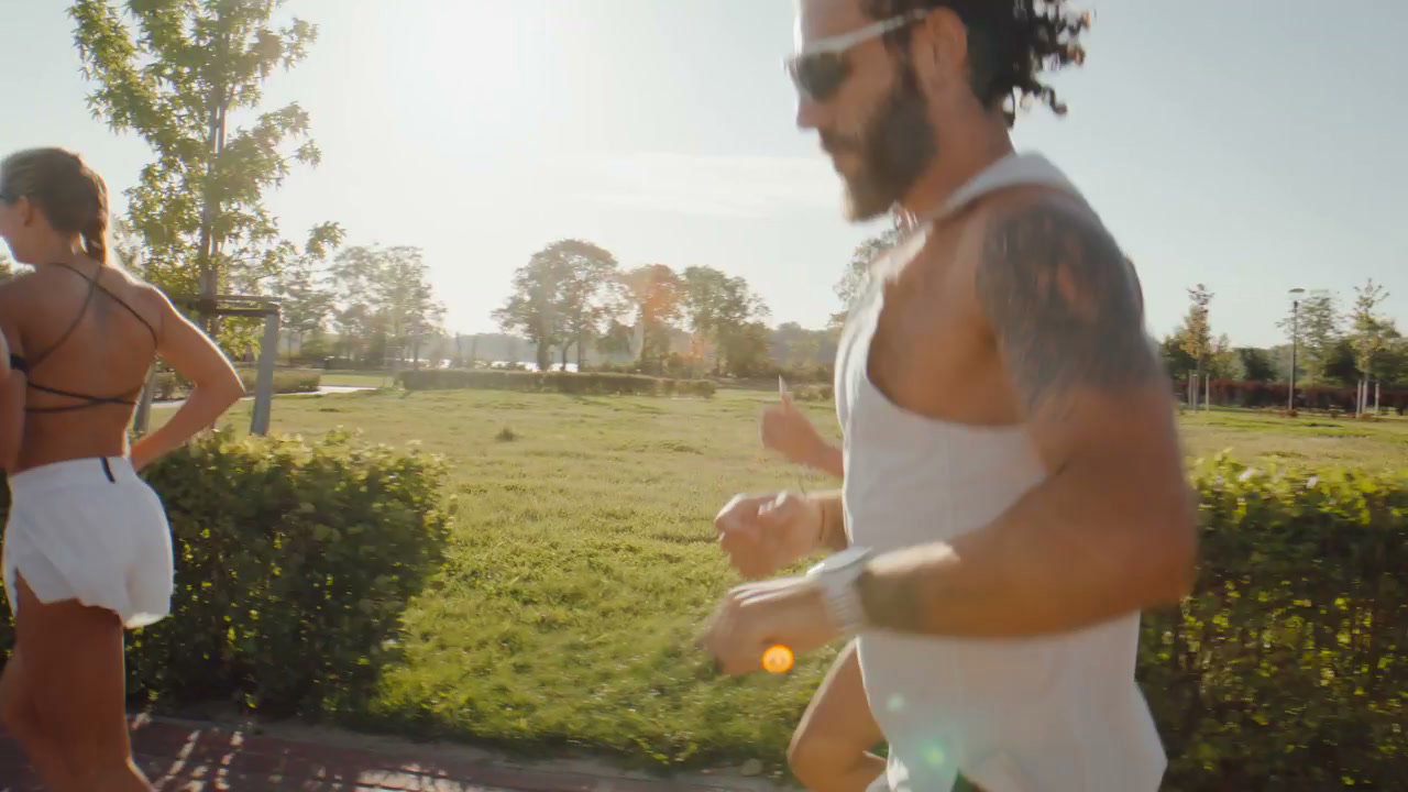 Athletes Jogging Together on Sunny Park Path