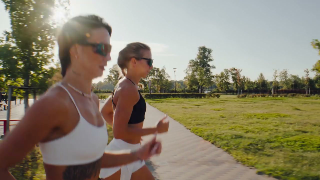 Two Women Running on Park Path