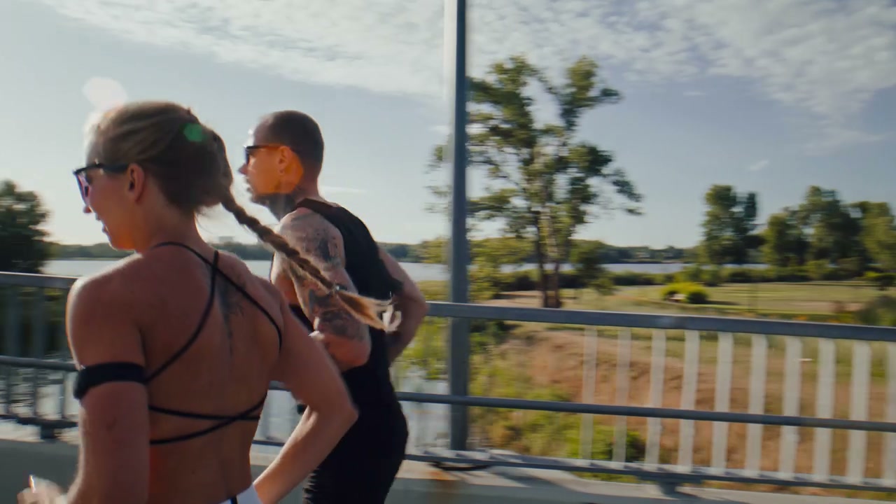 Four Runners Jogging on City Bridge