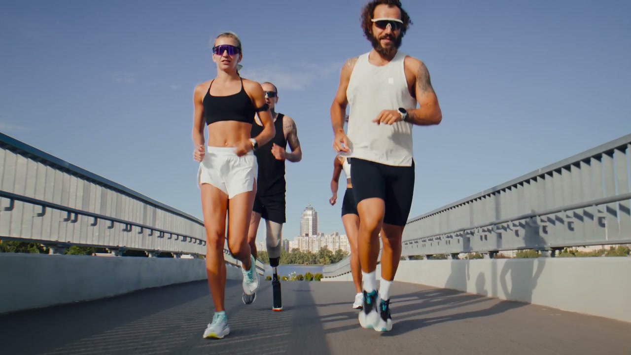 Diverse Runners Jogging on City Bridge