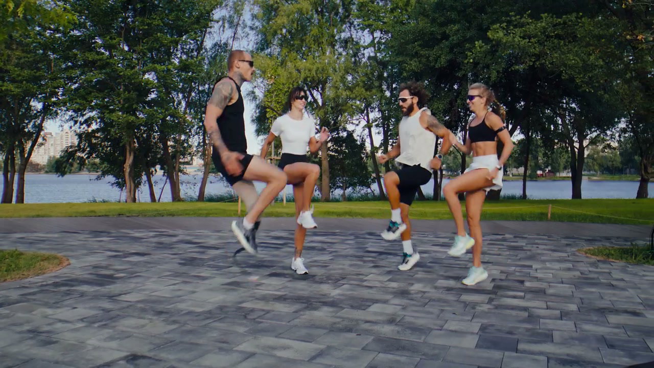 Athletes Warming Up with High Knees Exercise