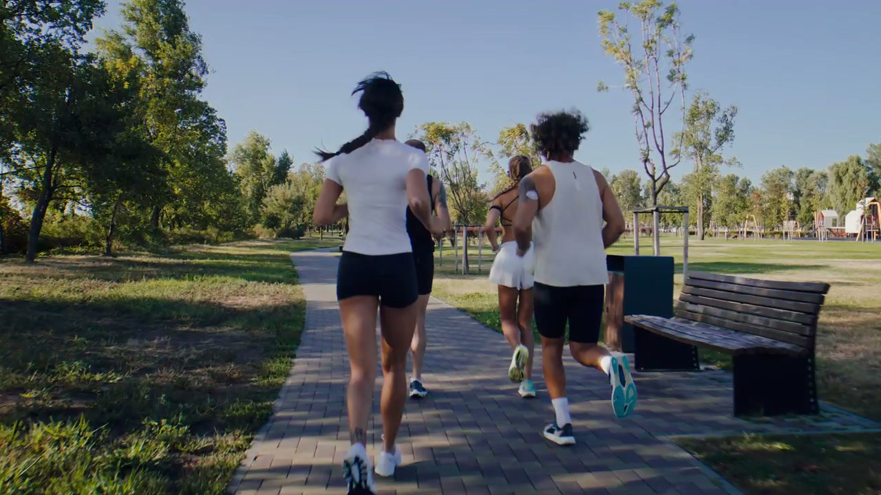 Diverse Group Running with Prosthetic in Park