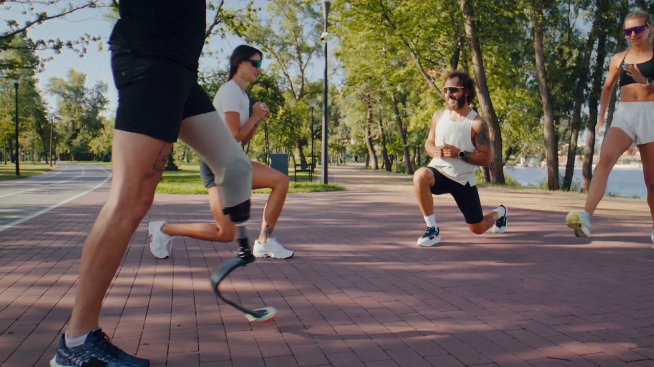 Man with Prosthetic Leg Doing Lunges with Group