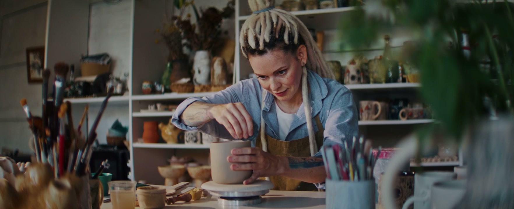 Woman Shaping Clay Pot in Ceramic Studio