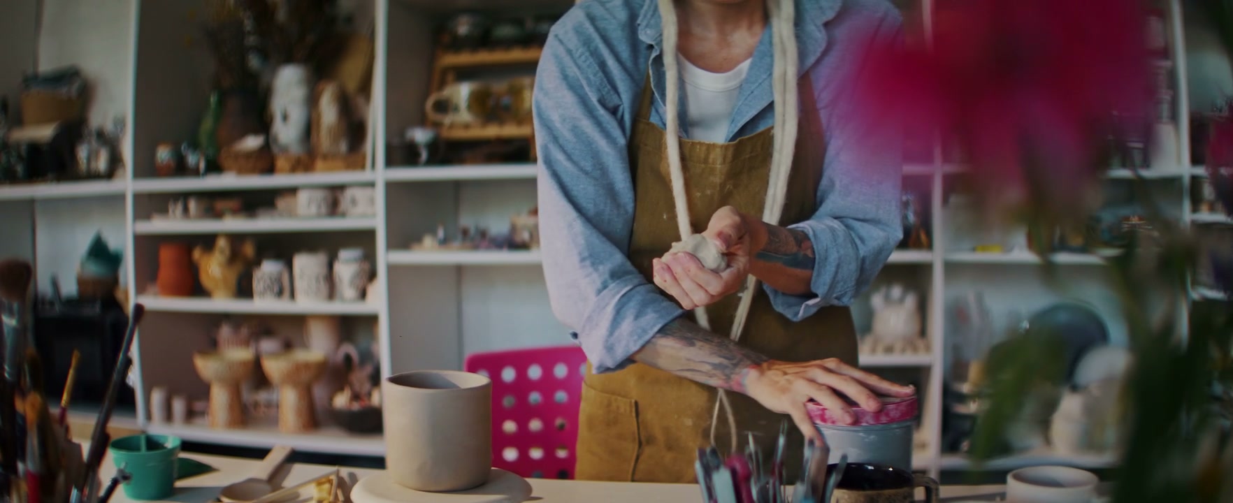 Hands Kneading Clay in Pottery Studio