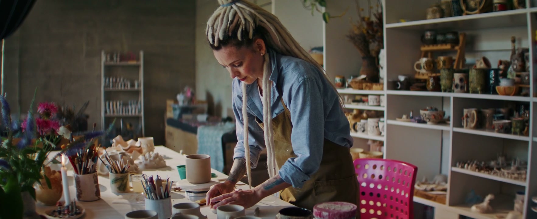 Woman Decorating Pottery in Ceramic Studio
