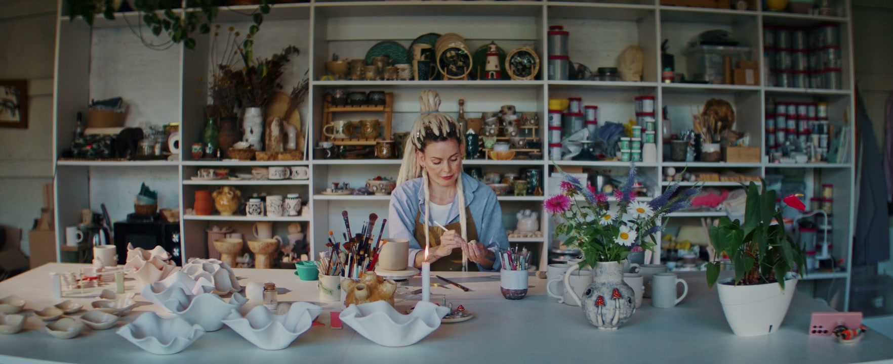 Woman Painting Ceramics in Studio