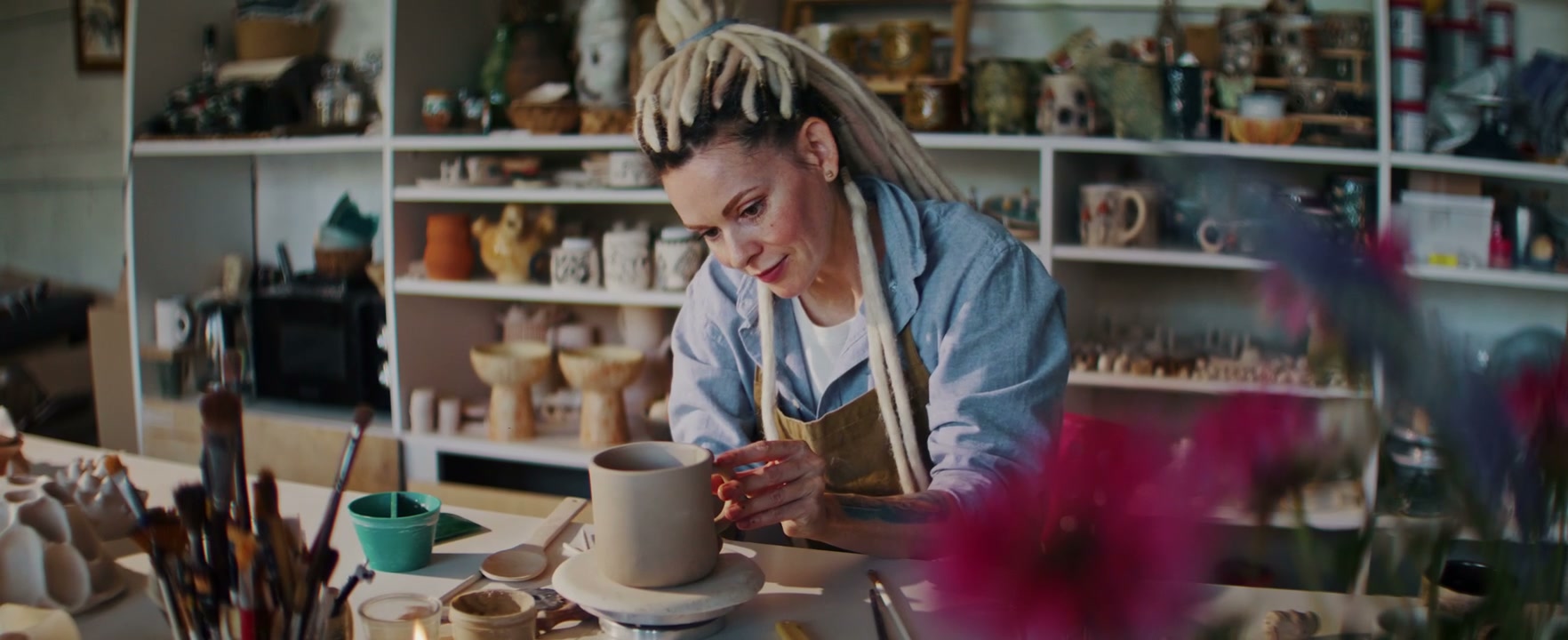 Artist Shaping Clay in Ceramic Studio
