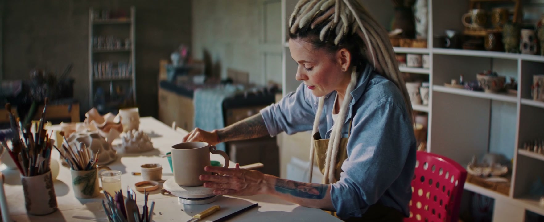 Potter Crafting Mug in Ceramic Studio