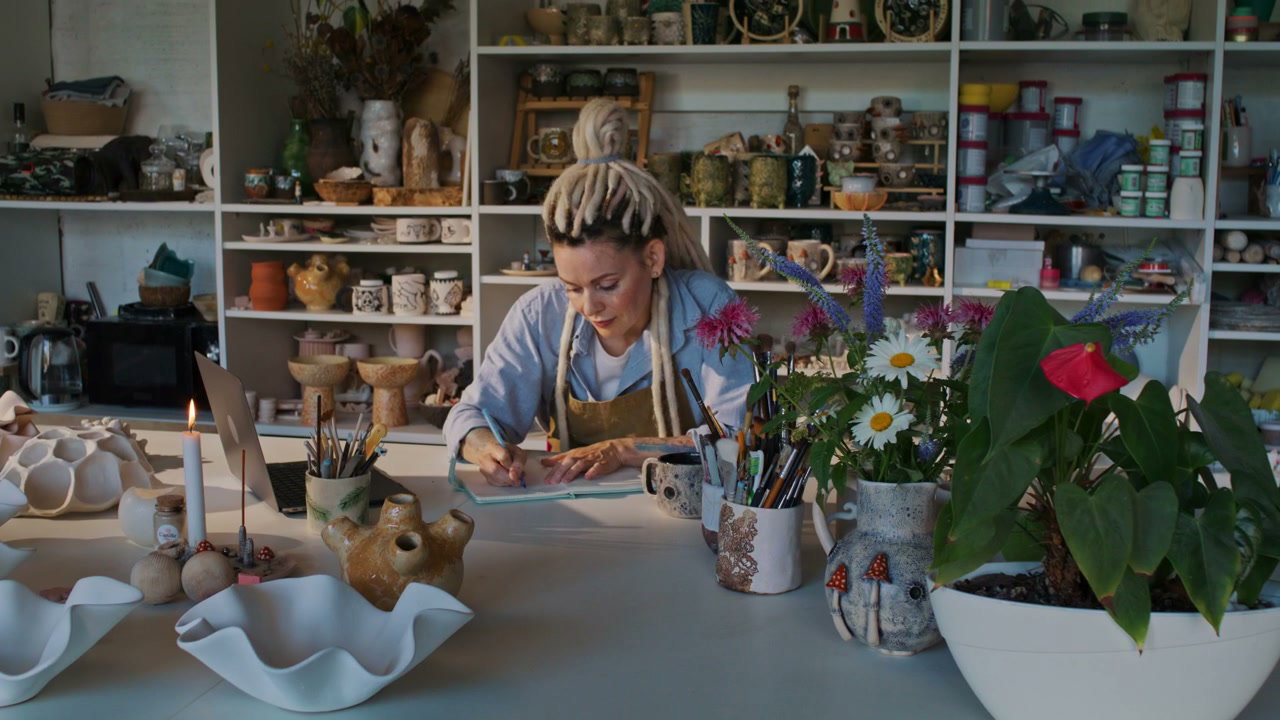 Woman Artist Designing in Pottery Studio