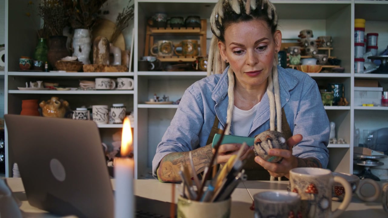 Artist Decorating Pottery in Studio