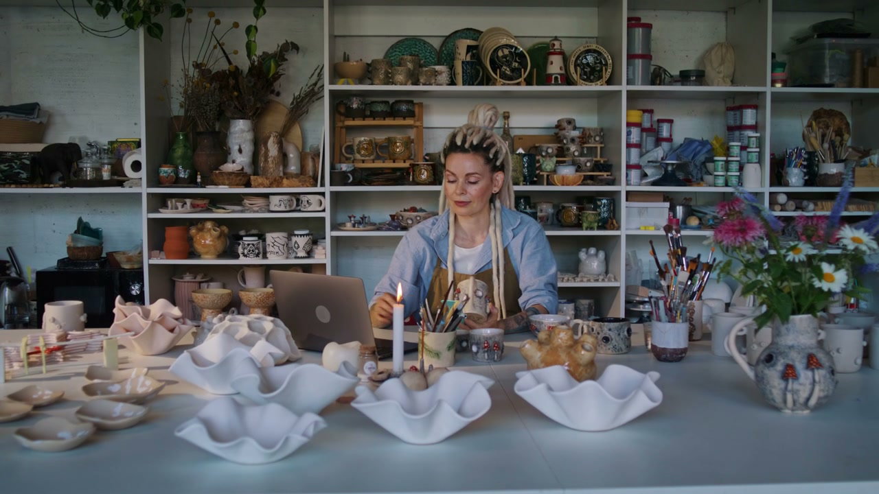 Woman Painting Pottery in Ceramic Studio