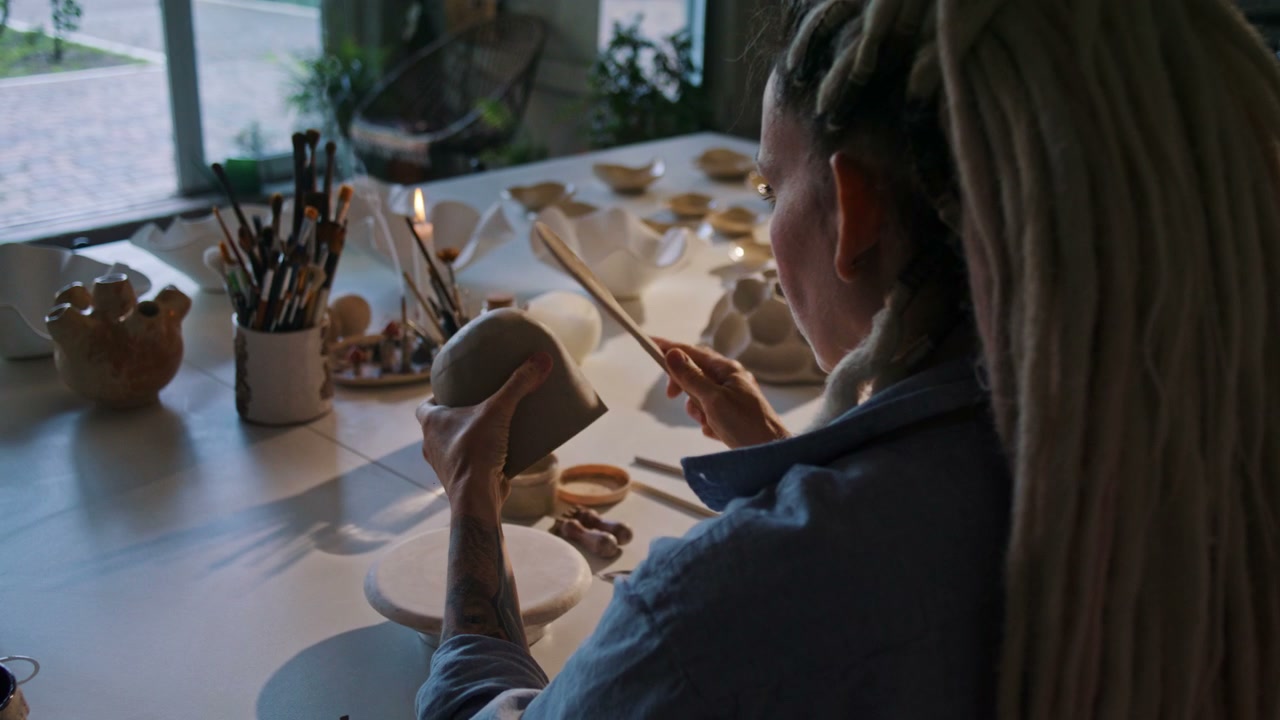 Artist Shaping Clay Pot in Ceramic Studio