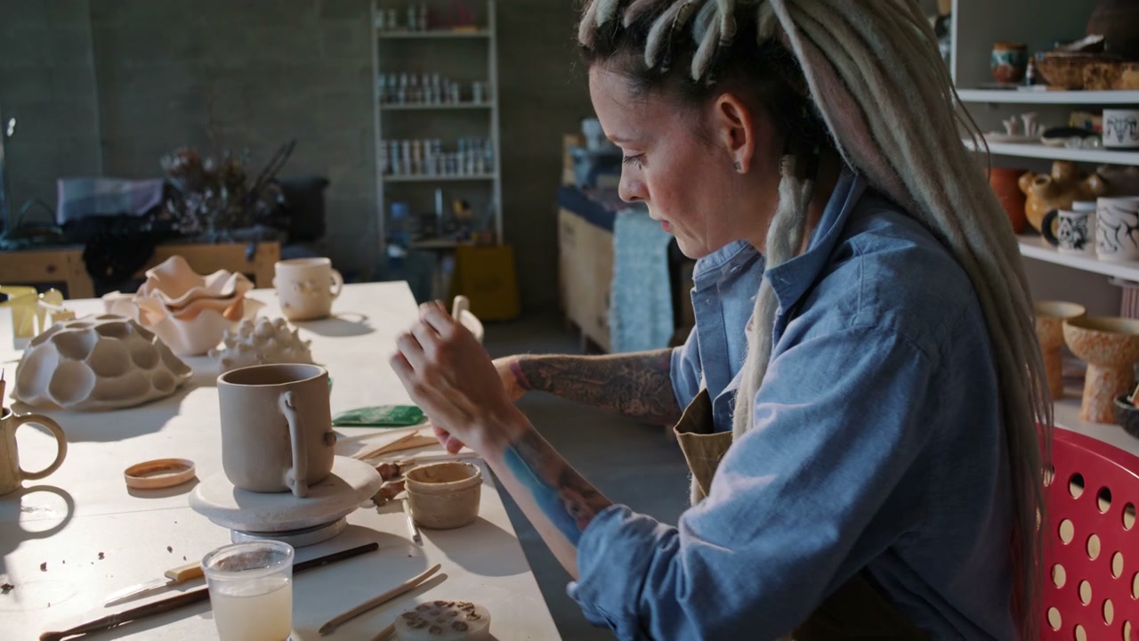 Woman Creating Ceramic Mug in Studio