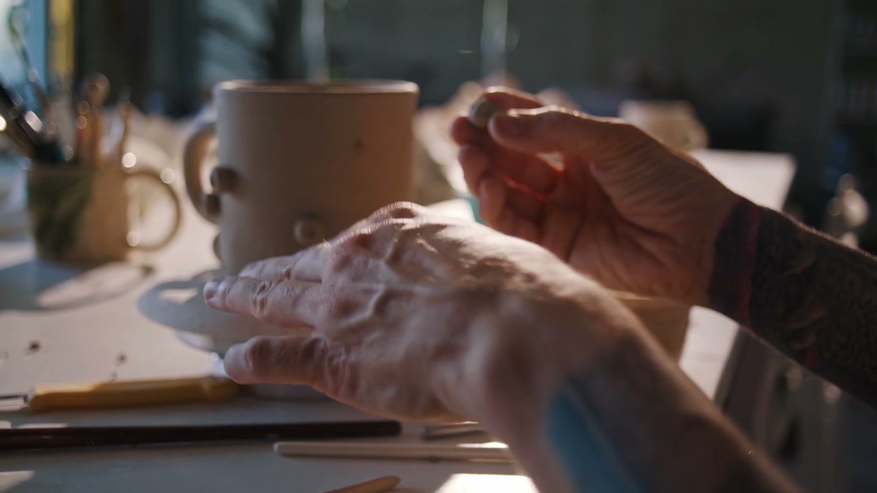 Potter Decorating Clay Mug