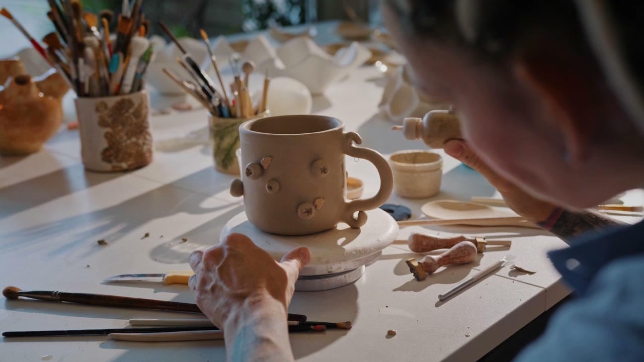 Potter Decorating Clay Mug
