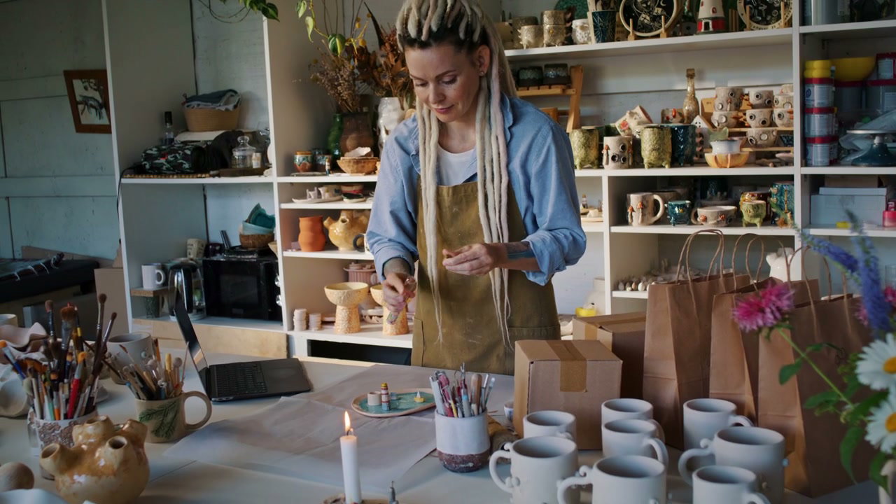 Woman Packaging Handmade Ceramics in Studio