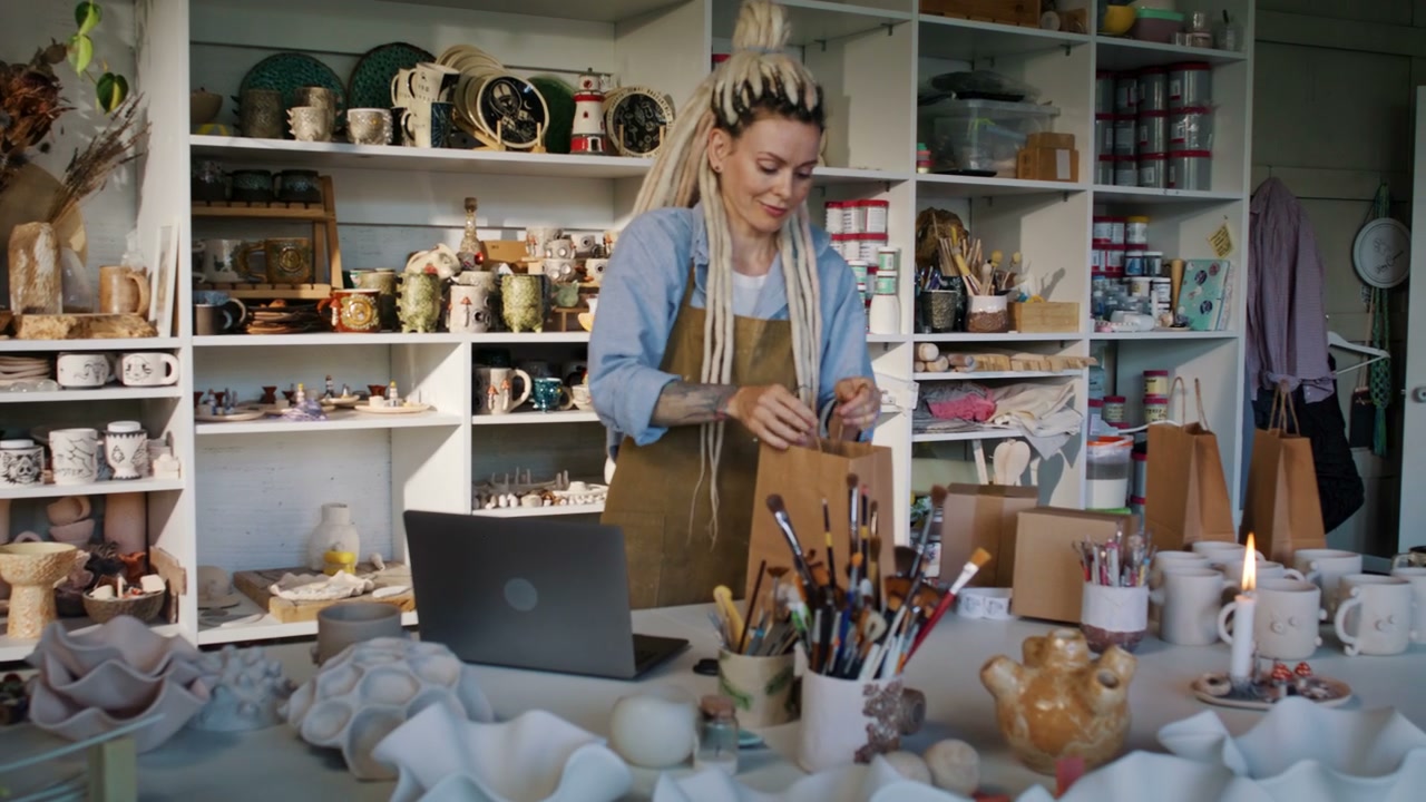 Woman Packing Order in Ceramic Studio