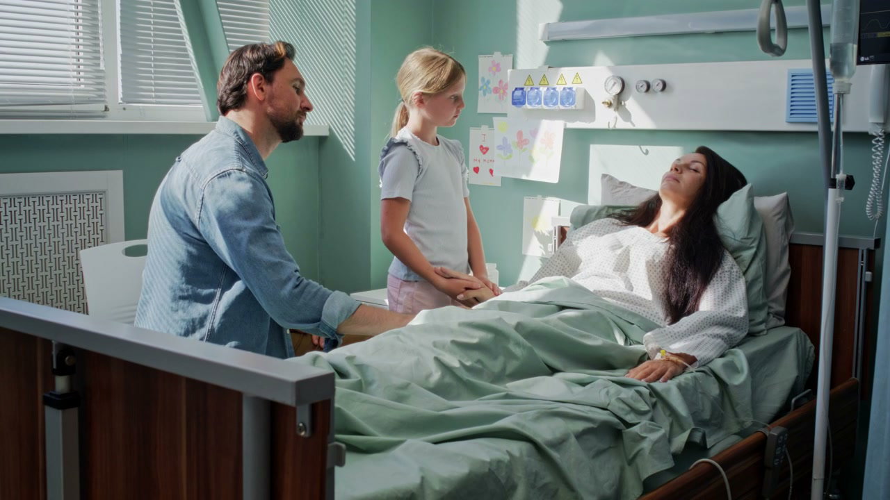 Family Visits Mother in Hospital Room