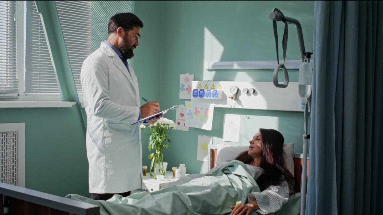 Doctor Consulting Patient in Hospital Room