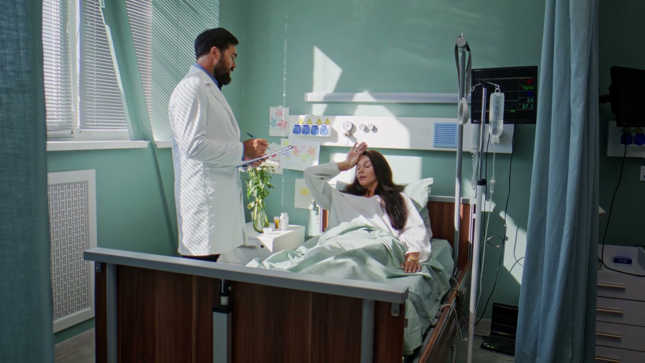Doctor Consults Female Patient in Hospital Bed