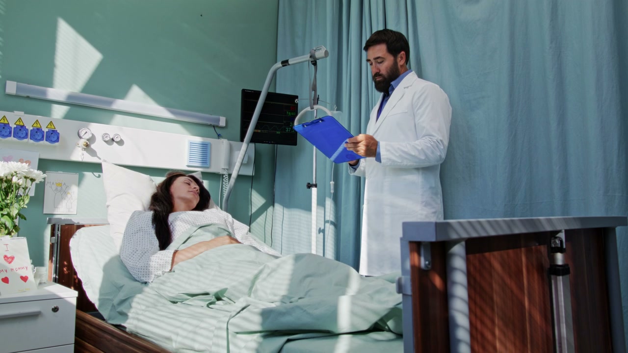 Doctor Consults Patient in Hospital Room