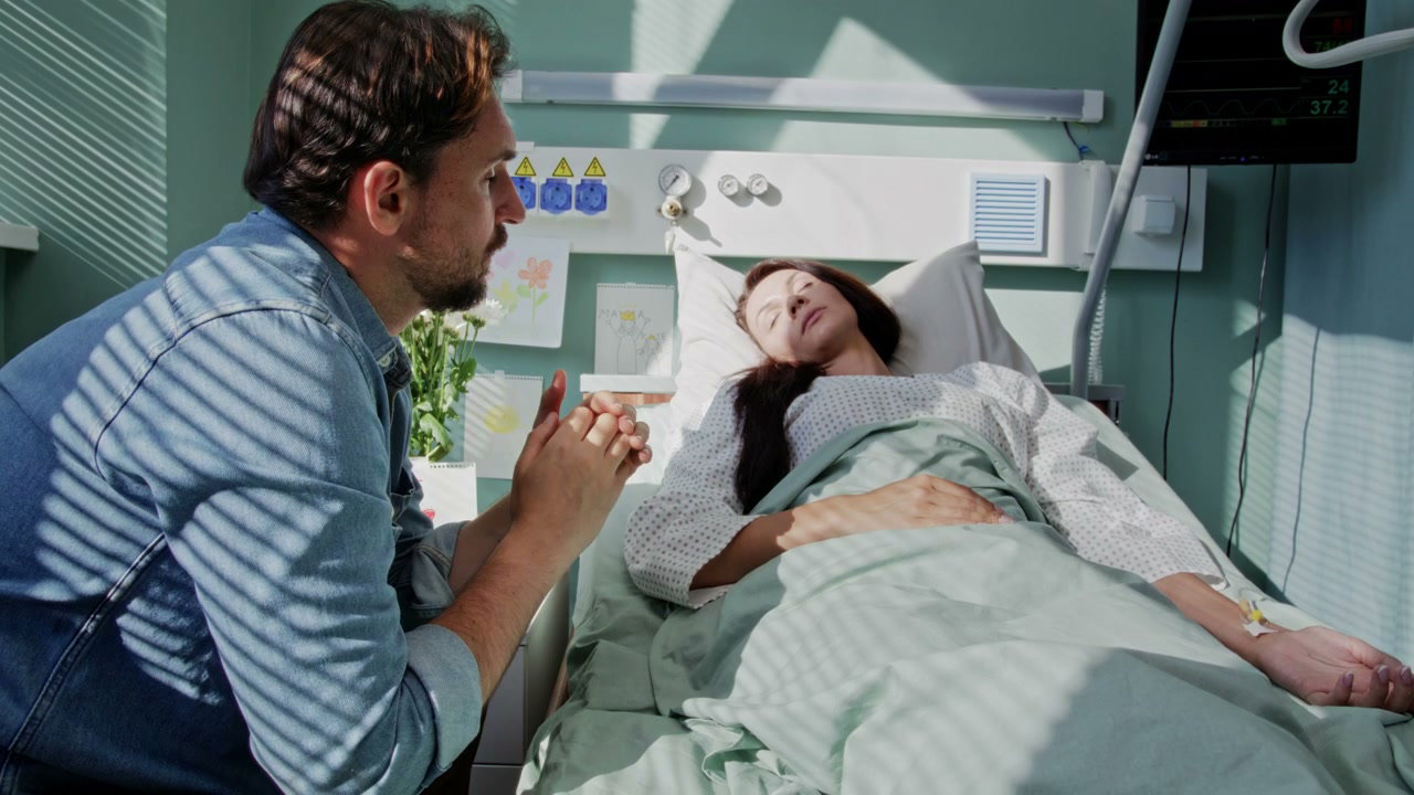 Distressed Man by Hospital Bedside