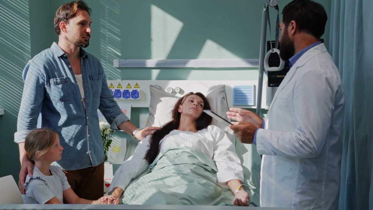 Doctor Talks to Patient and Family in Hospital