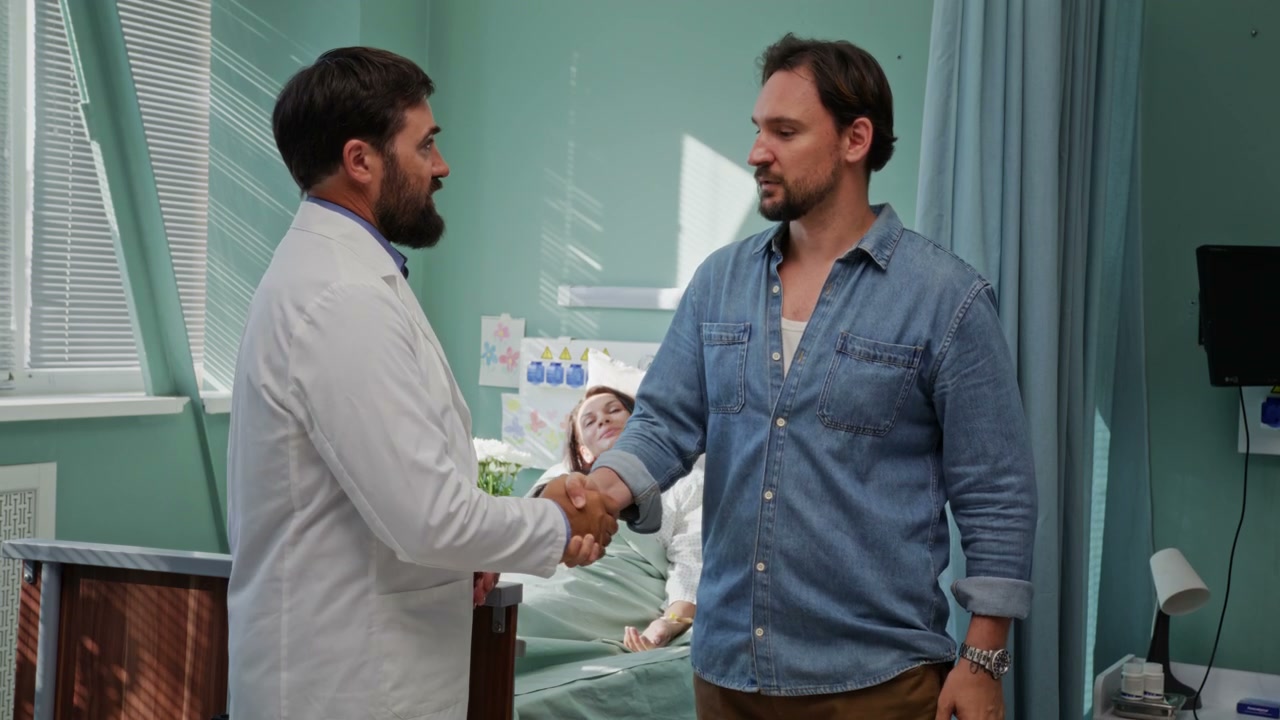 Doctor Shakes Hand with Man in Hospital