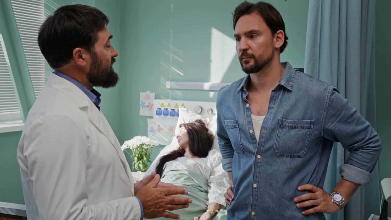 Doctor Talks to Worried Partner at Hospital