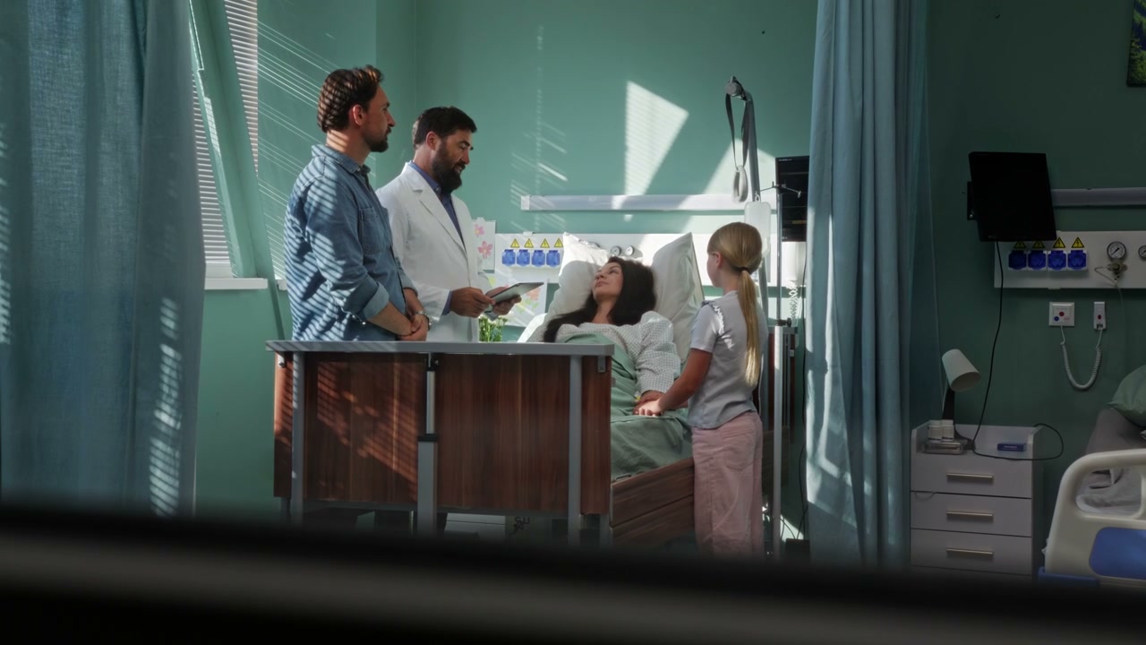 Doctor Talks to Family by Hospital Bed
