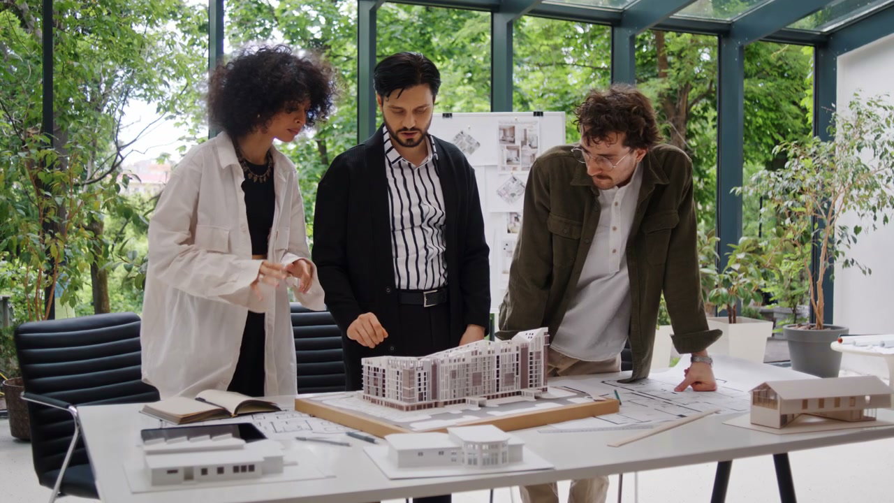 Architects Discussing Building Model and Blueprints