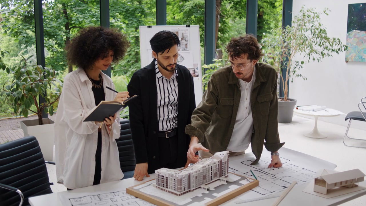 Architects Discuss Building Model in Office