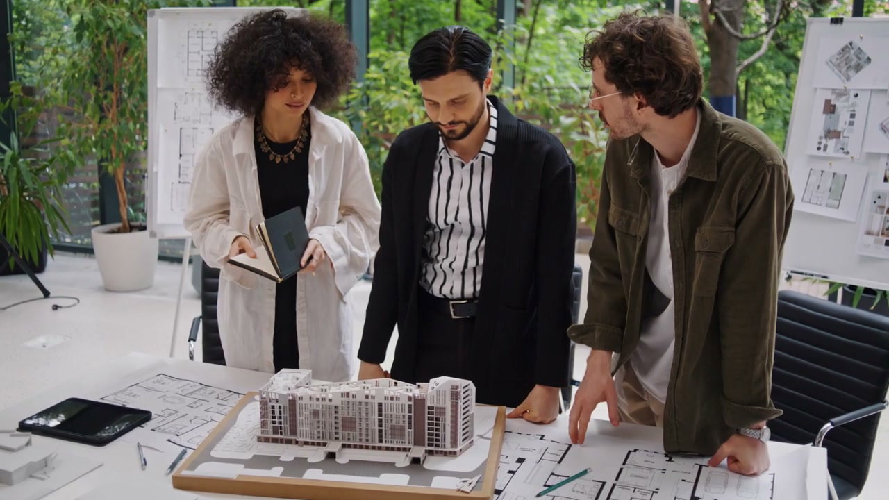 Architects Discuss Building Model in Office